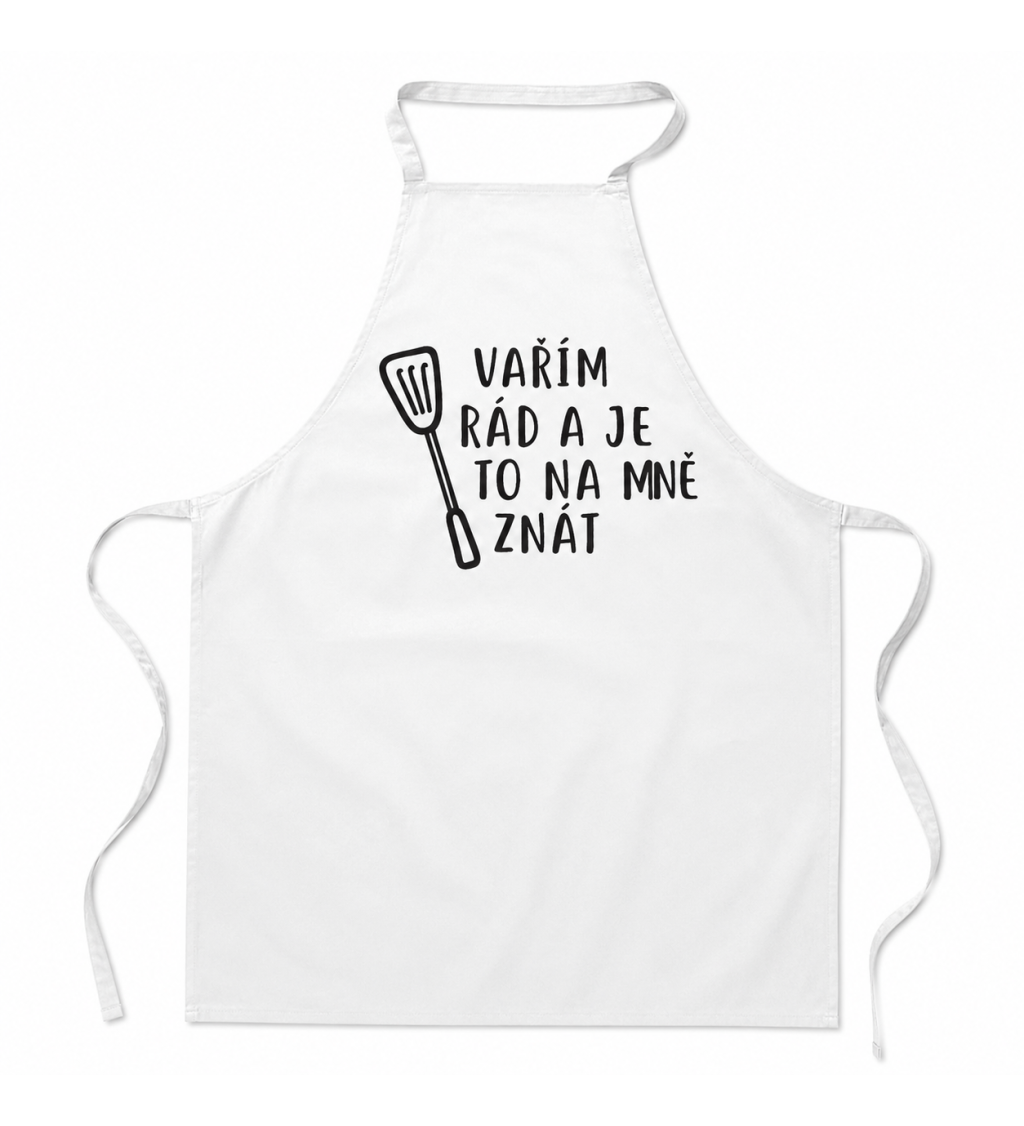 Bílá zástěra s nápisem - Vařím rád a je to na mě znát
