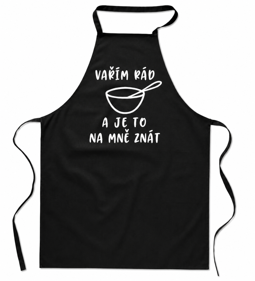 Černá zástěra s nápisem - Vařím rád a je to na mě znát
